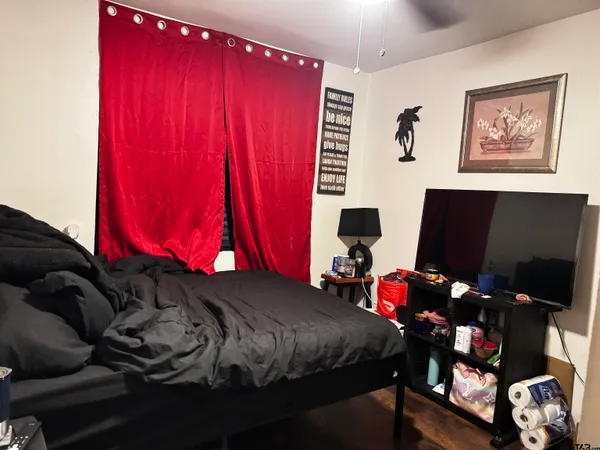 a bedroom with bed and a window