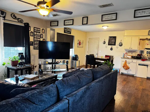 a living room with fireplace furniture and a flat screen tv