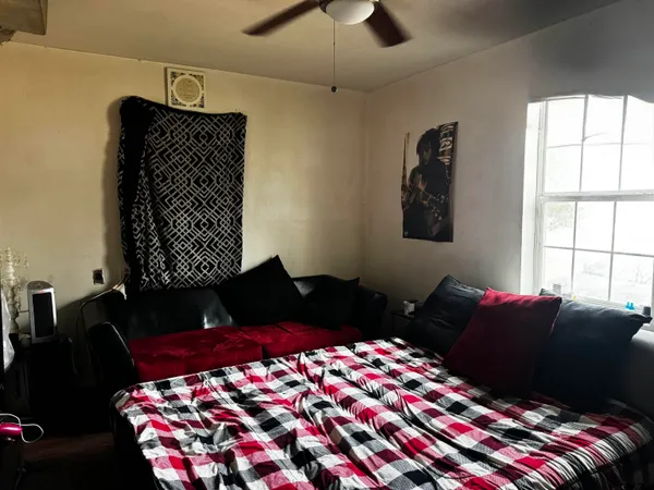 a bedroom with a bed window and lamp