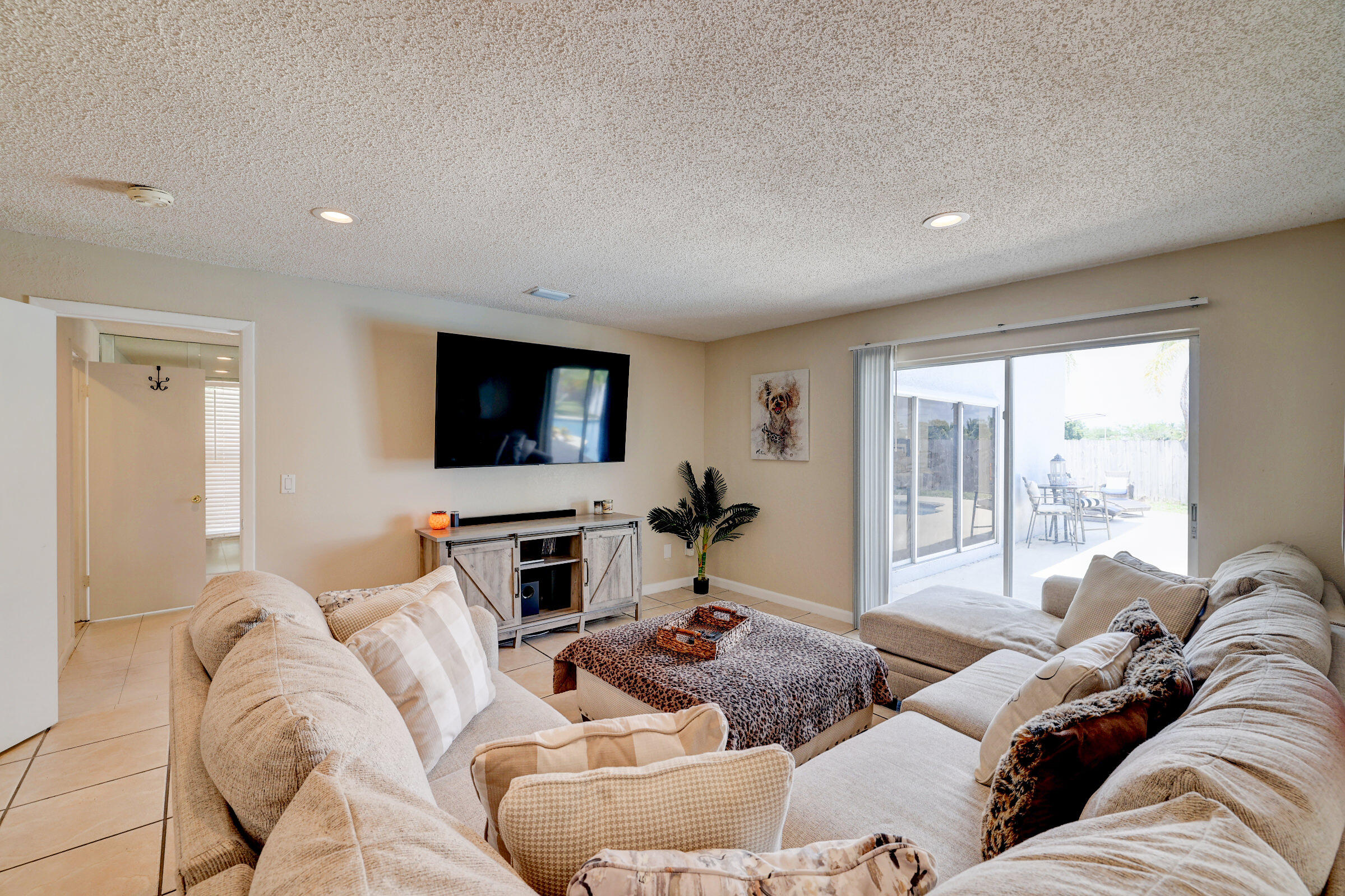 2068 Southeast Triumph Road Port St. Lucie, FL 34952 - Photo 13 of 59 a living room with furniture and a flat screen tv