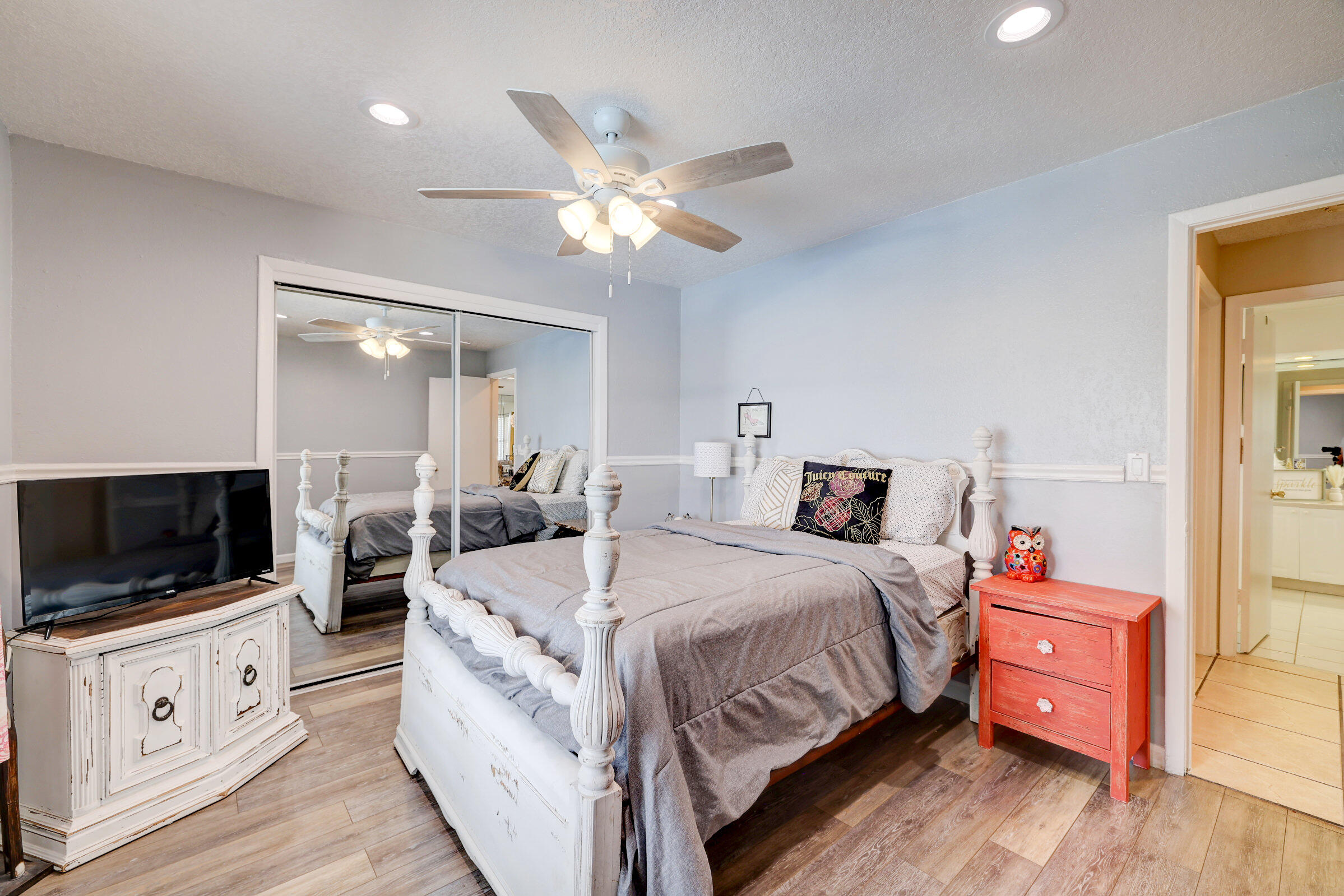 2068 Southeast Triumph Road Port St. Lucie, FL 34952 - Photo 14 of 59 a spacious bedroom with a bed and a flat screen tv