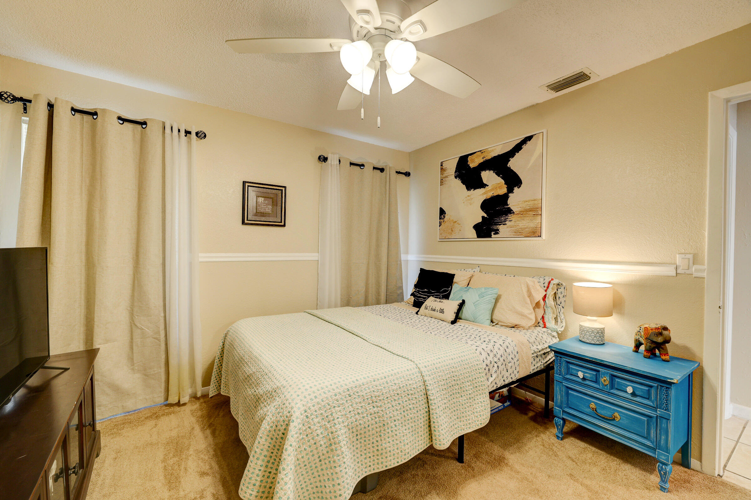 2068 Southeast Triumph Road Port St. Lucie, FL 34952 - Photo 16 of 59 a bedroom with a bed dresser and a window