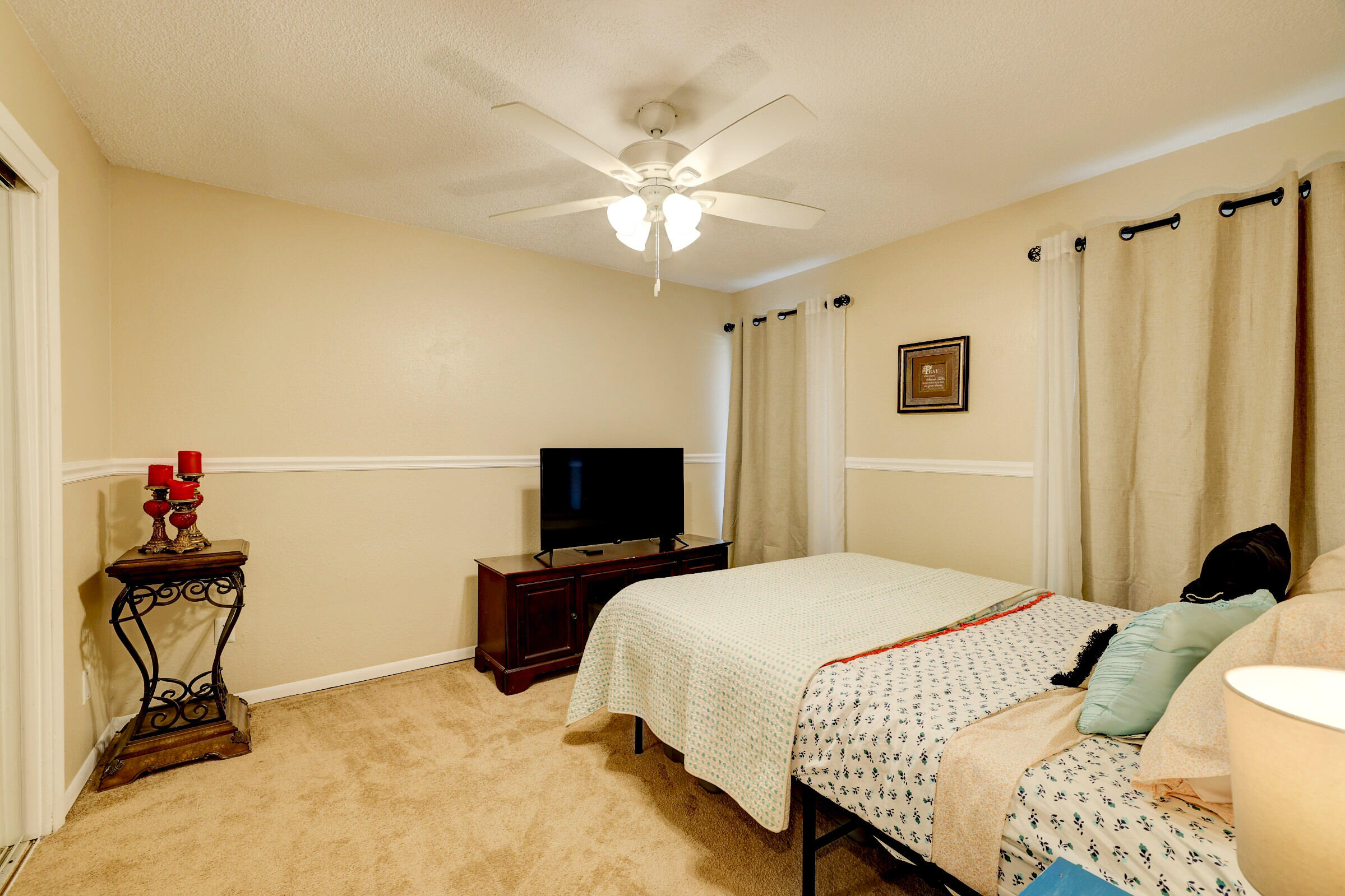 2068 Southeast Triumph Road Port St. Lucie, FL 34952 - Photo 17 of 59 a bedroom with a bed and a chandelier