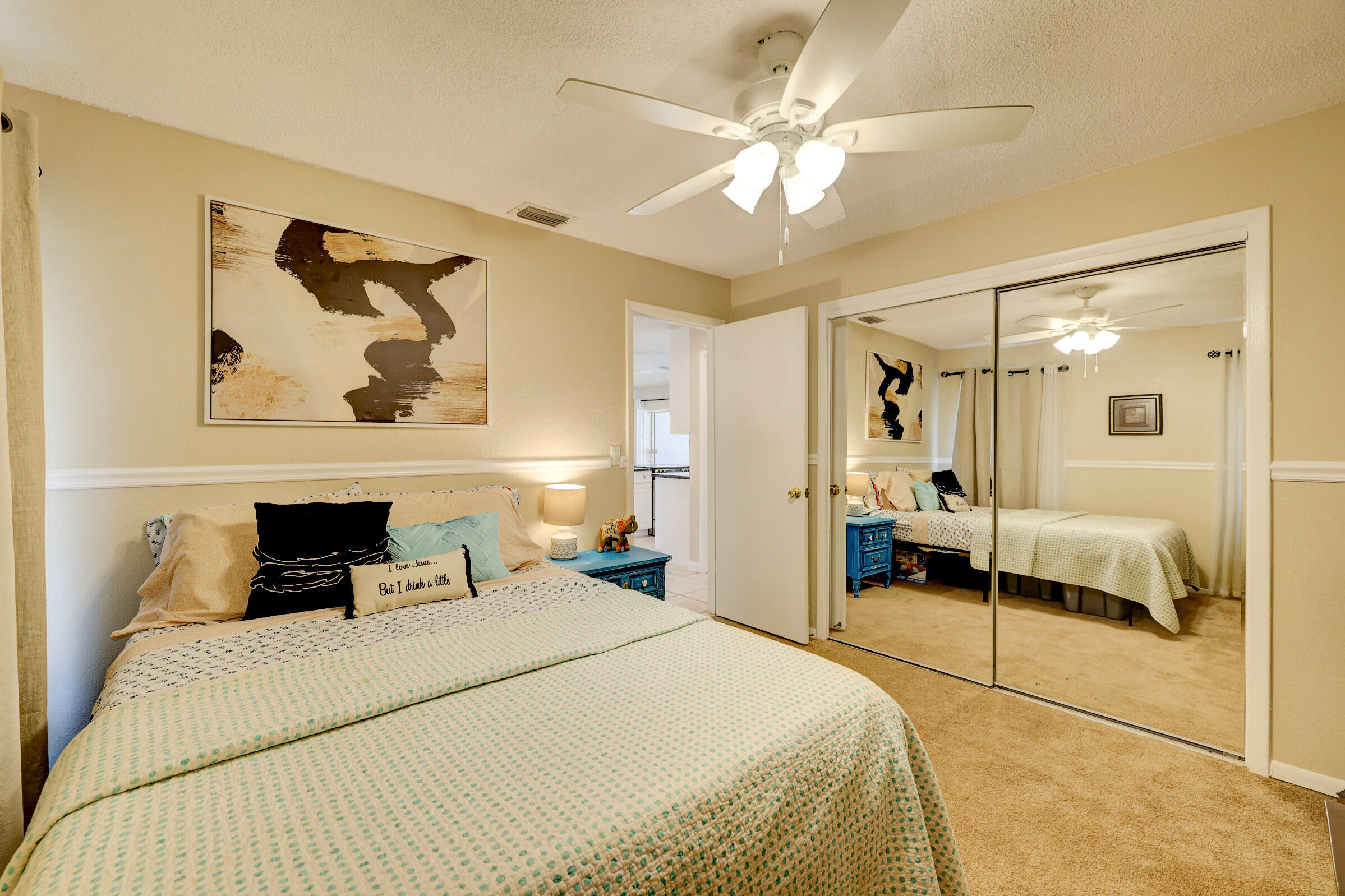 2068 Southeast Triumph Road Port St. Lucie, FL 34952 - Photo 18 of 59 a bedroom with a bed and a painting on the wall