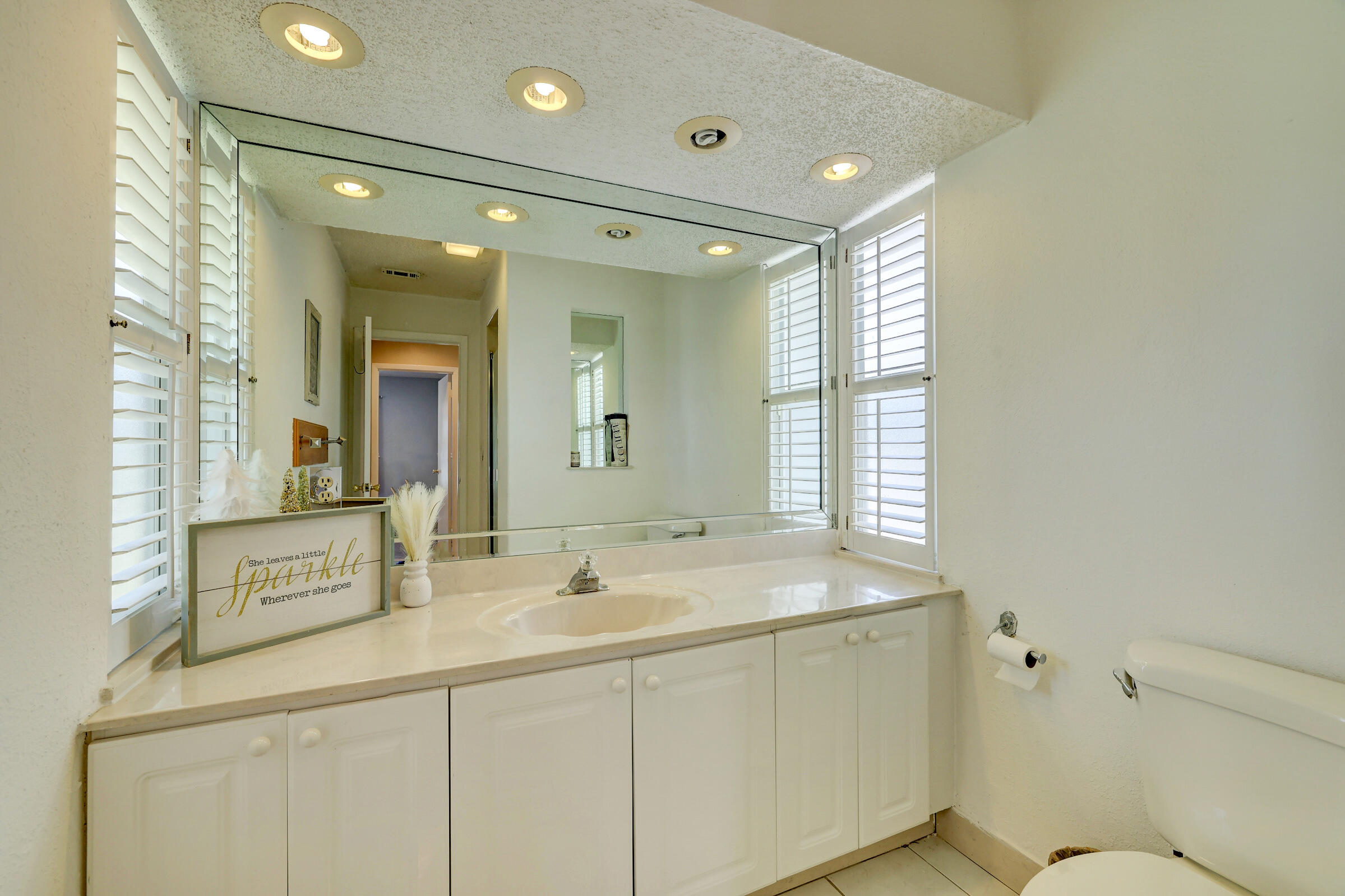 2068 Southeast Triumph Road Port St. Lucie, FL 34952 - Photo 19 of 59 a bathroom with a sink and a mirror