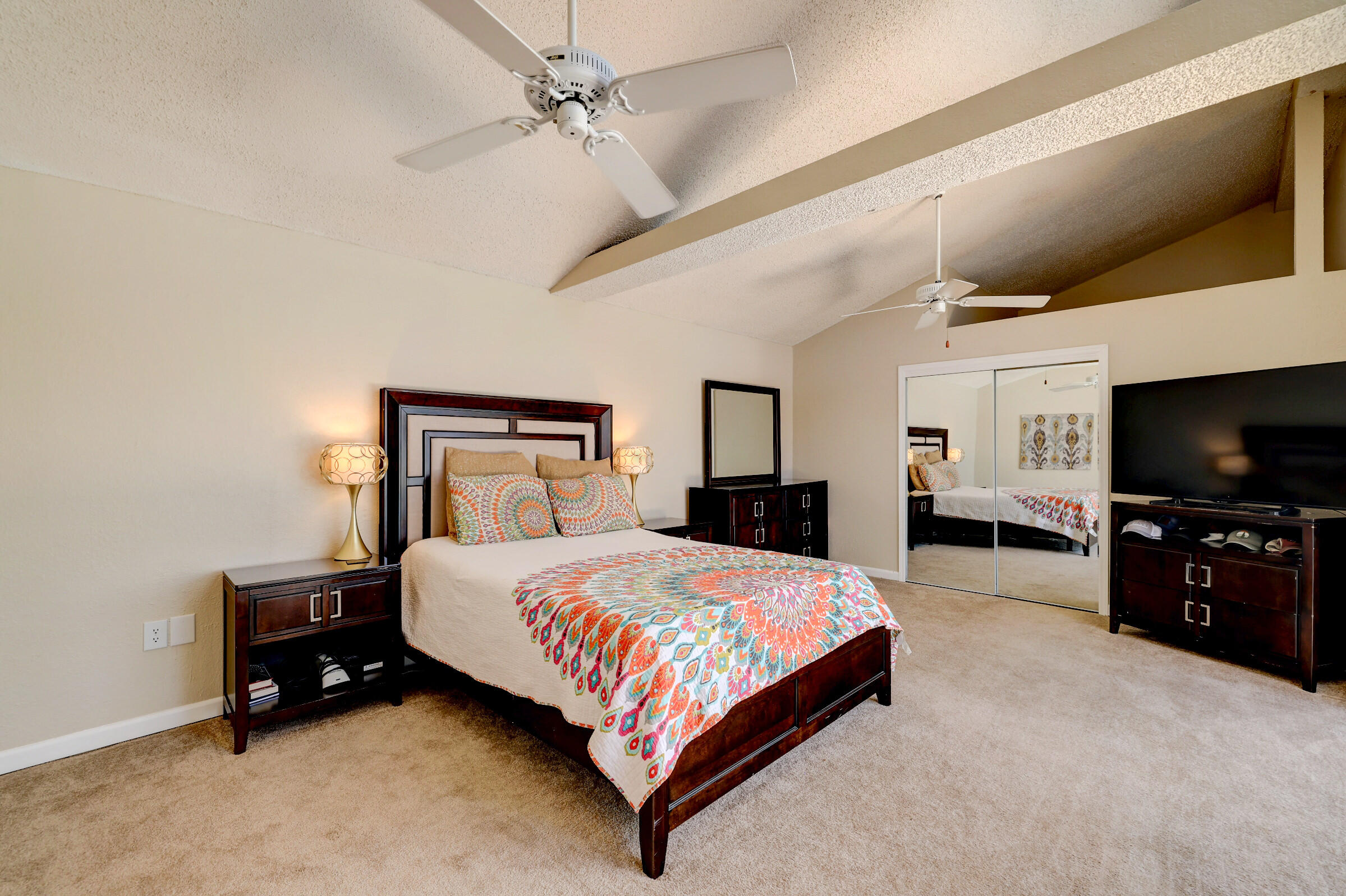 2068 Southeast Triumph Road Port St. Lucie, FL 34952 - Photo 21 of 59 a bedroom with a bed and a flat screen tv