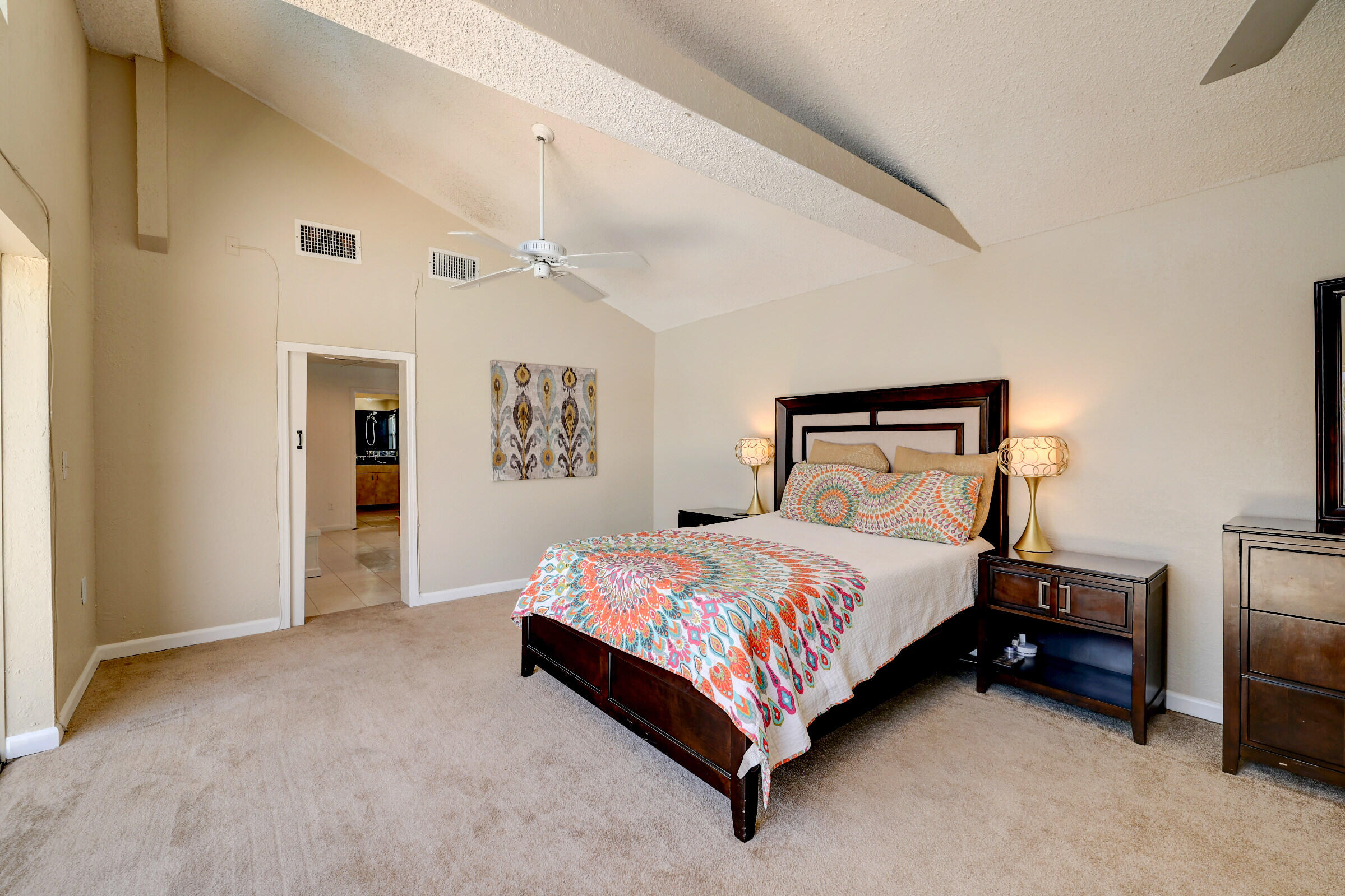2068 Southeast Triumph Road Port St. Lucie, FL 34952 - Photo 23 of 59 a bedroom with a bed lamp and a ceiling fan
