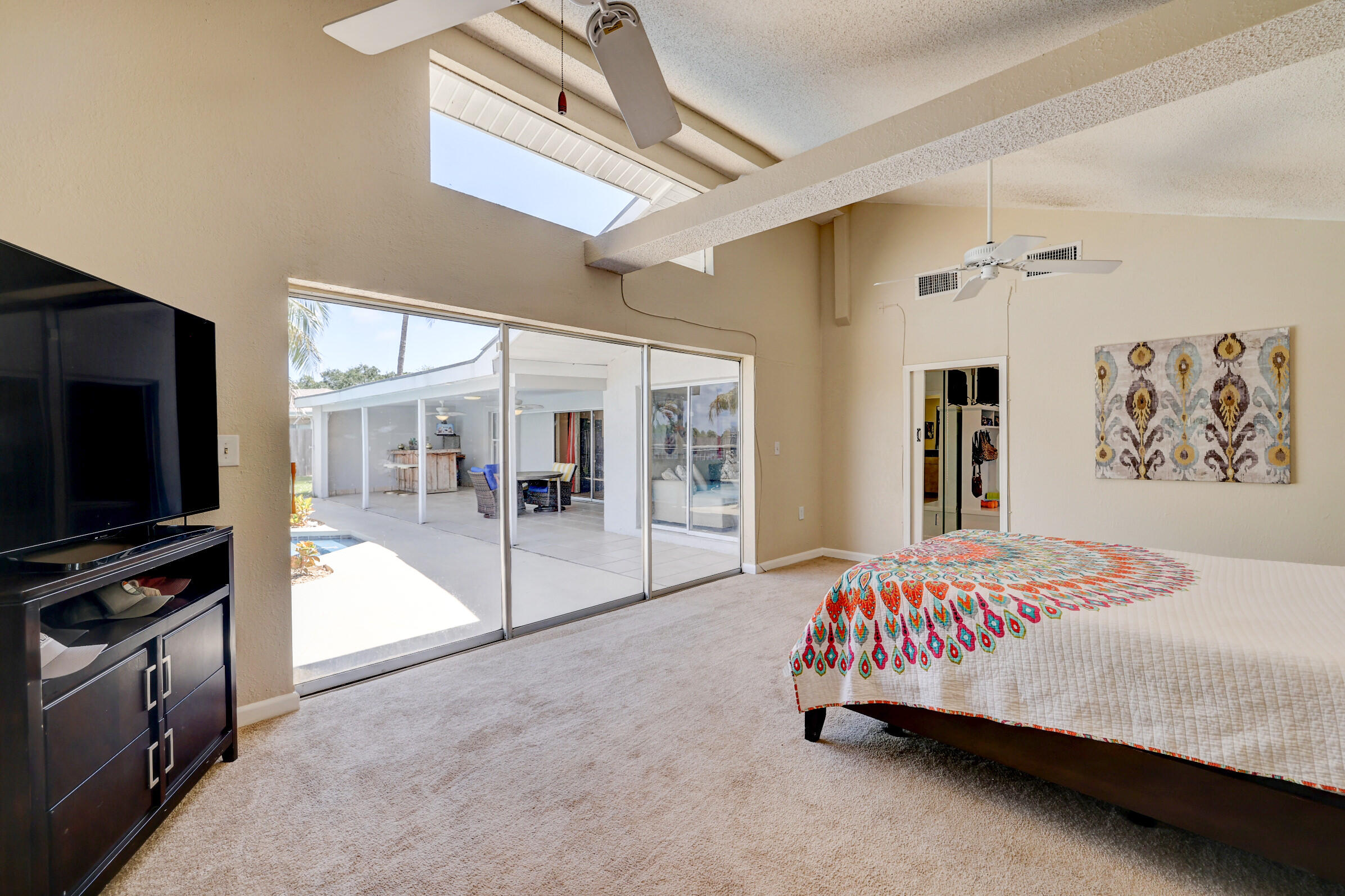 2068 Southeast Triumph Road Port St. Lucie, FL 34952 - Photo 24 of 59 a bedroom with a bed and flat screen tv