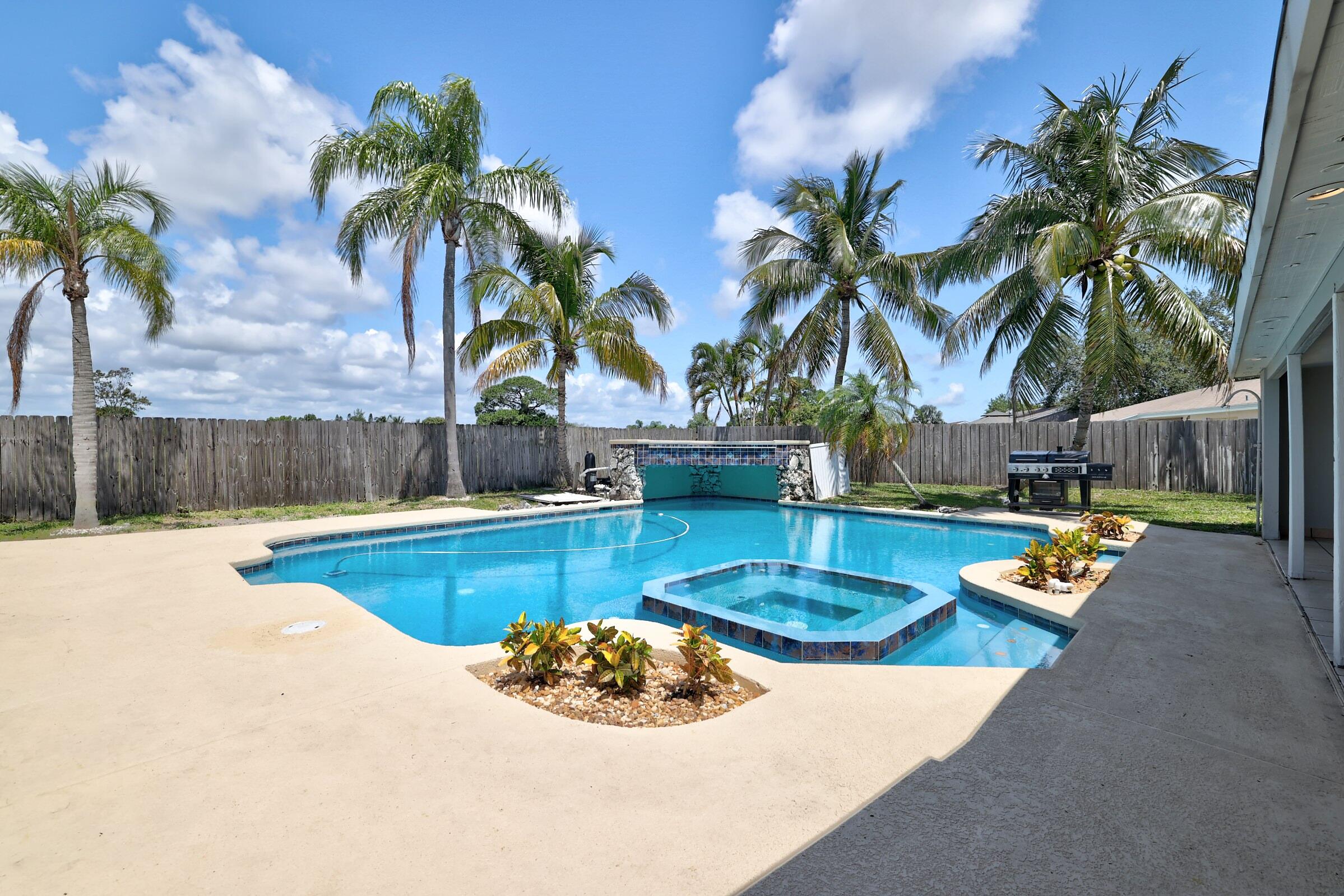 2068 Southeast Triumph Road Port St. Lucie, FL 34952 - Photo 33 of 59 a view of a backyard with swimming pool