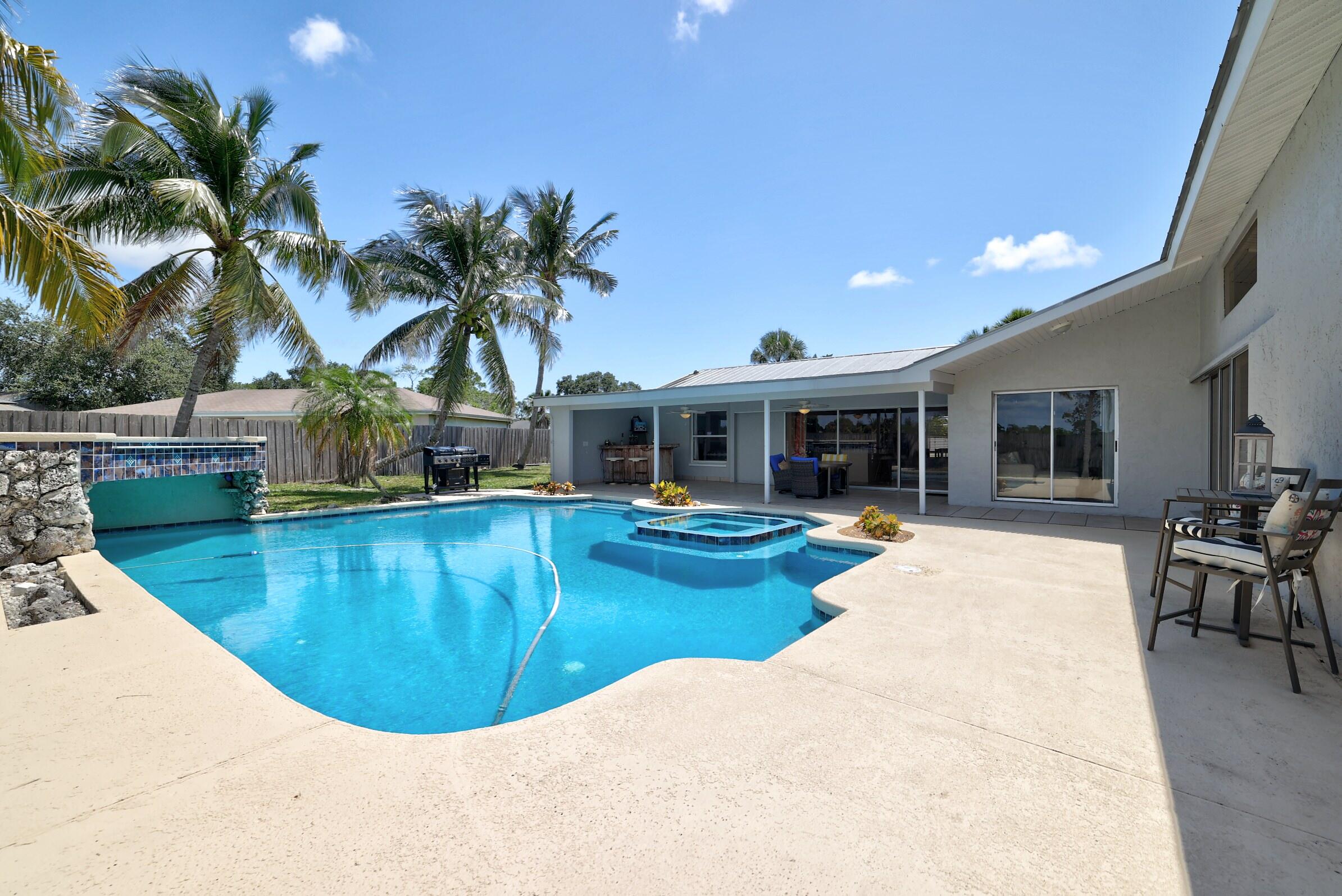 2068 Southeast Triumph Road Port St. Lucie, FL 34952 - Photo 34 of 59 a view of a house with swimming pool and sitting area