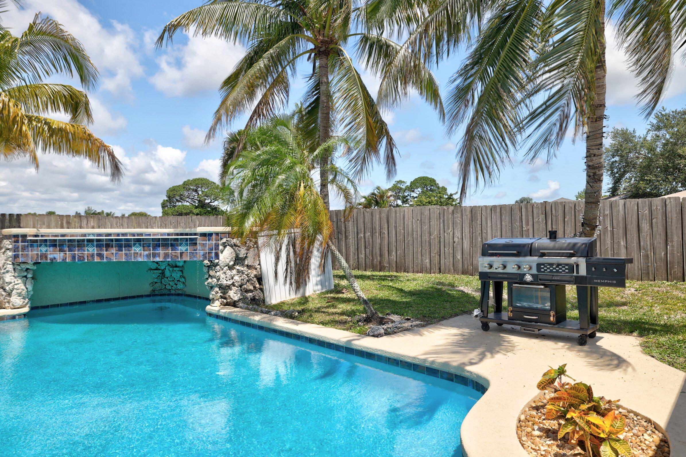 2068 Southeast Triumph Road Port St. Lucie, FL 34952 - Photo 35 of 59 a view of a backyard with a garden