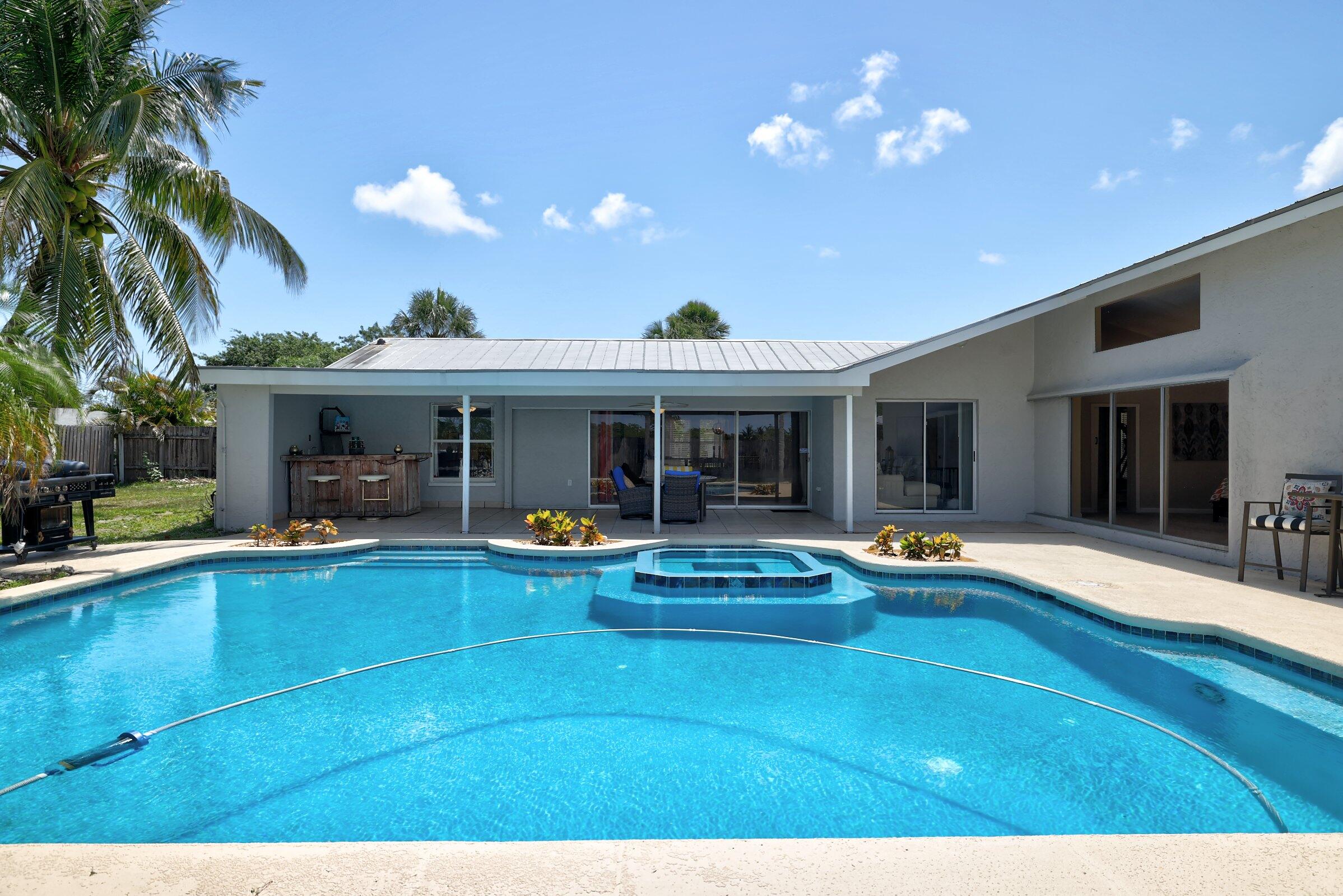 2068 Southeast Triumph Road Port St. Lucie, FL 34952 - Photo 37 of 59 a view of a house with swimming pool and sitting area