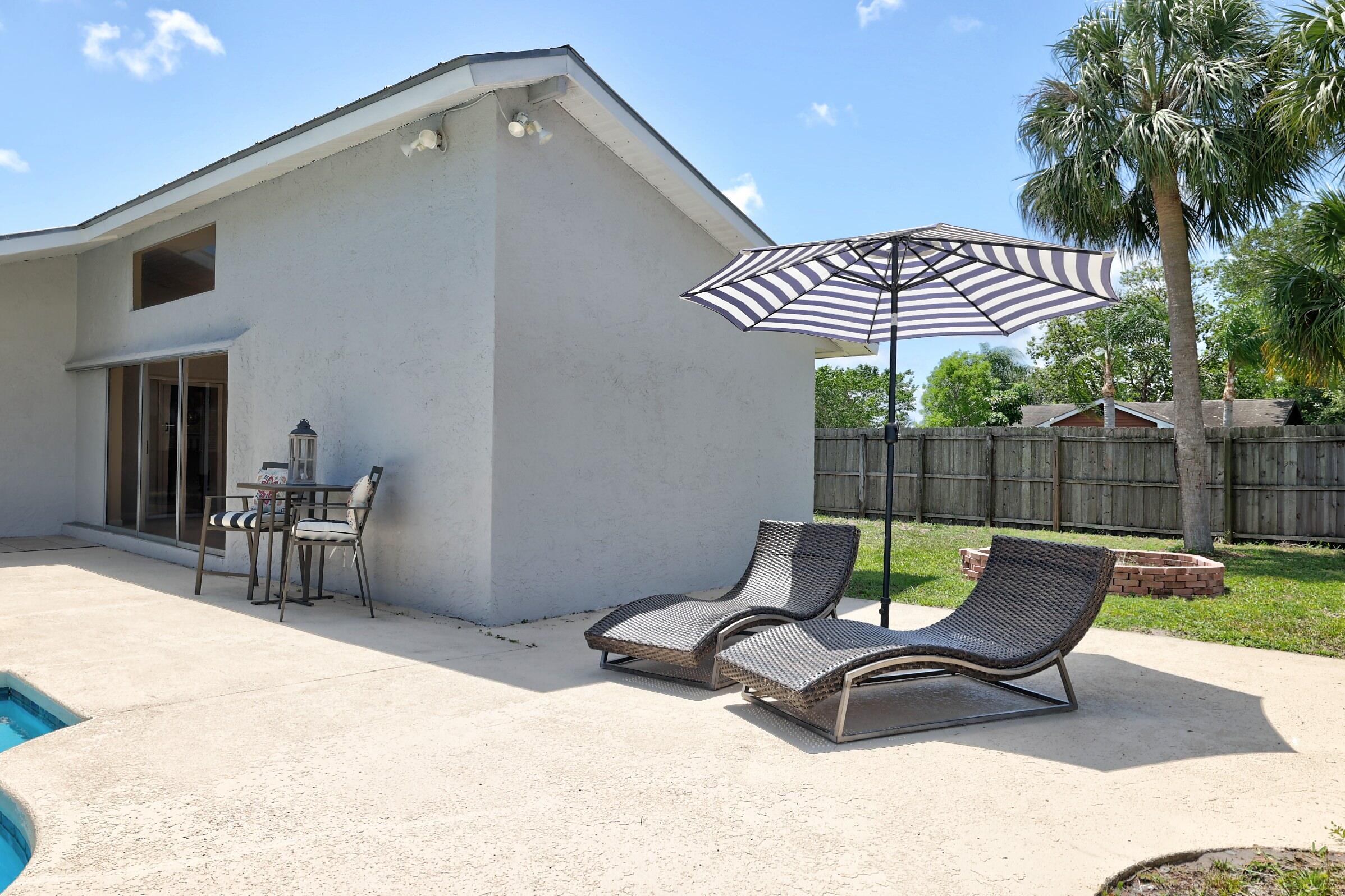 2068 Southeast Triumph Road Port St. Lucie, FL 34952 - Photo 38 of 59 a view of a two chairs in patio and yard