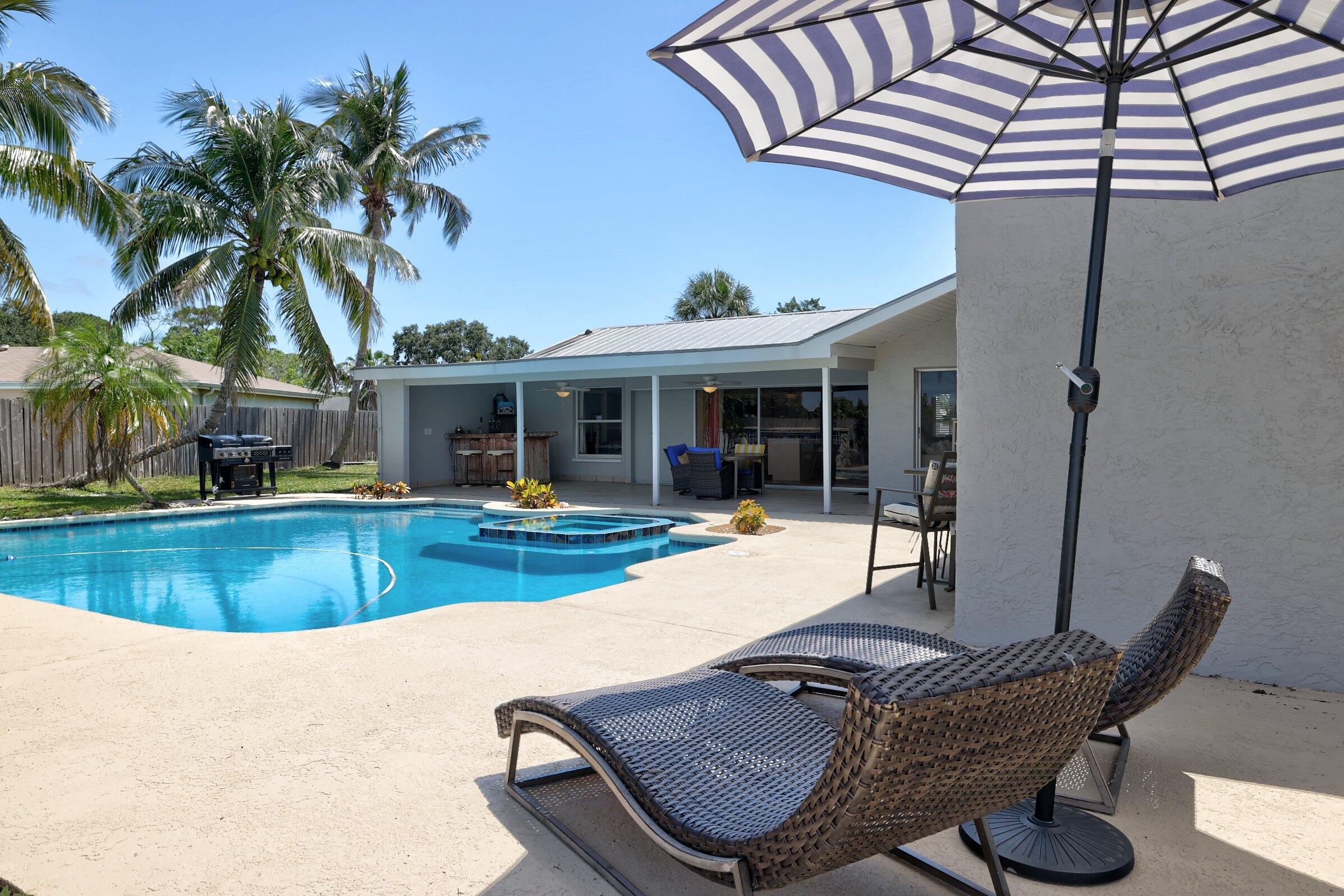 2068 Southeast Triumph Road Port St. Lucie, FL 34952 - Photo 39 of 59 a view of a house with swimming pool and sitting area