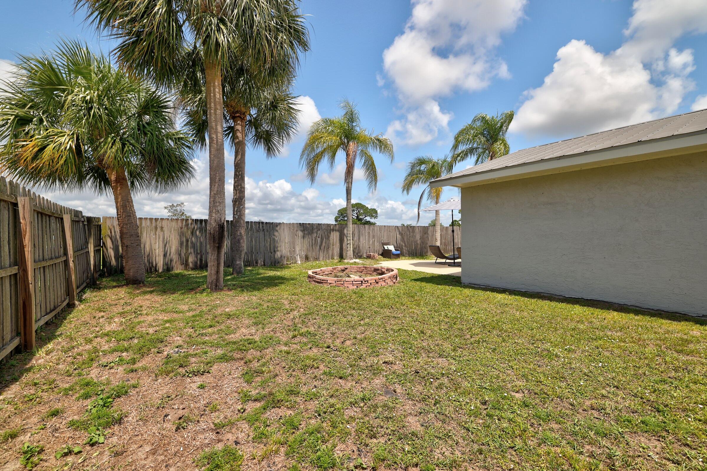 2068 Southeast Triumph Road Port St. Lucie, FL 34952 - Photo 40 of 59 a view of a yard with a patio