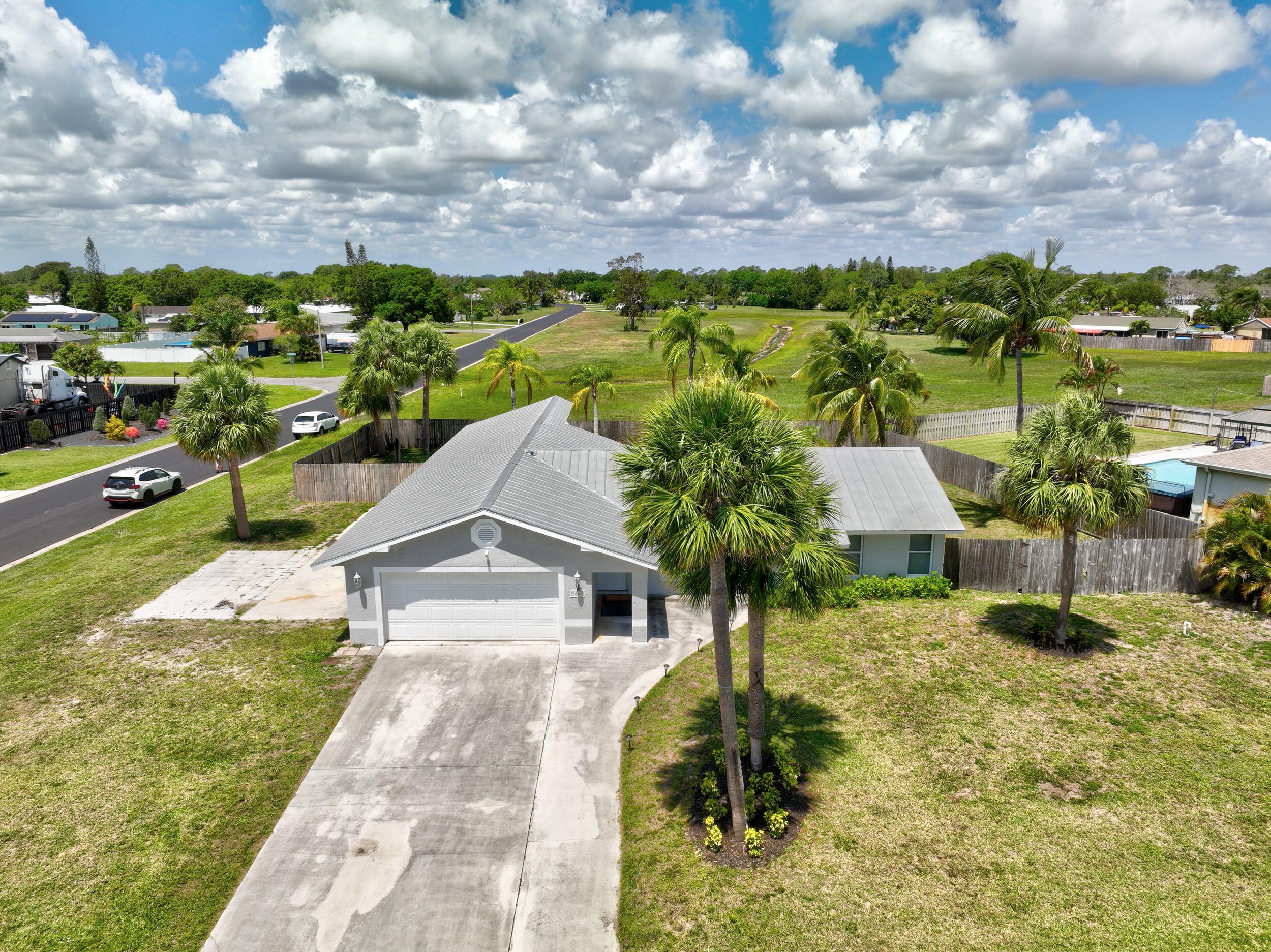 2068 Southeast Triumph Road Port St. Lucie, FL 34952 - Photo 45 of 59 a view of residential houses with yard
