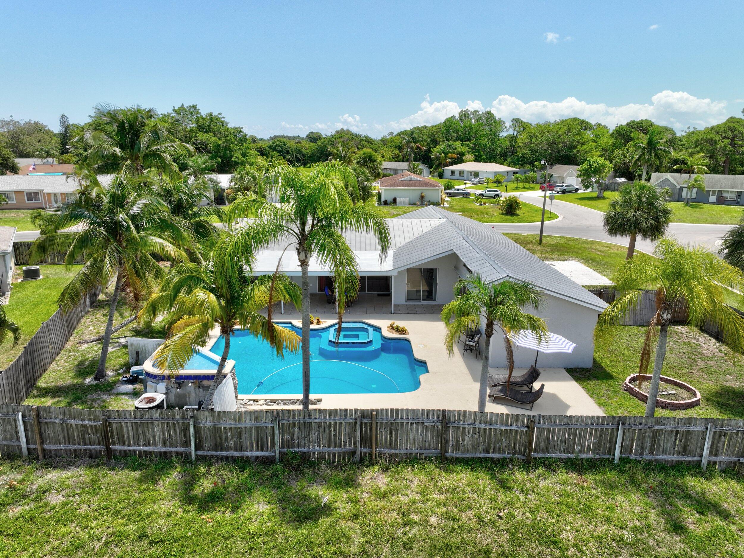 2068 Southeast Triumph Road Port St. Lucie, FL 34952 - Photo 55 of 59 an aerial view of a house with a garden and lake view
