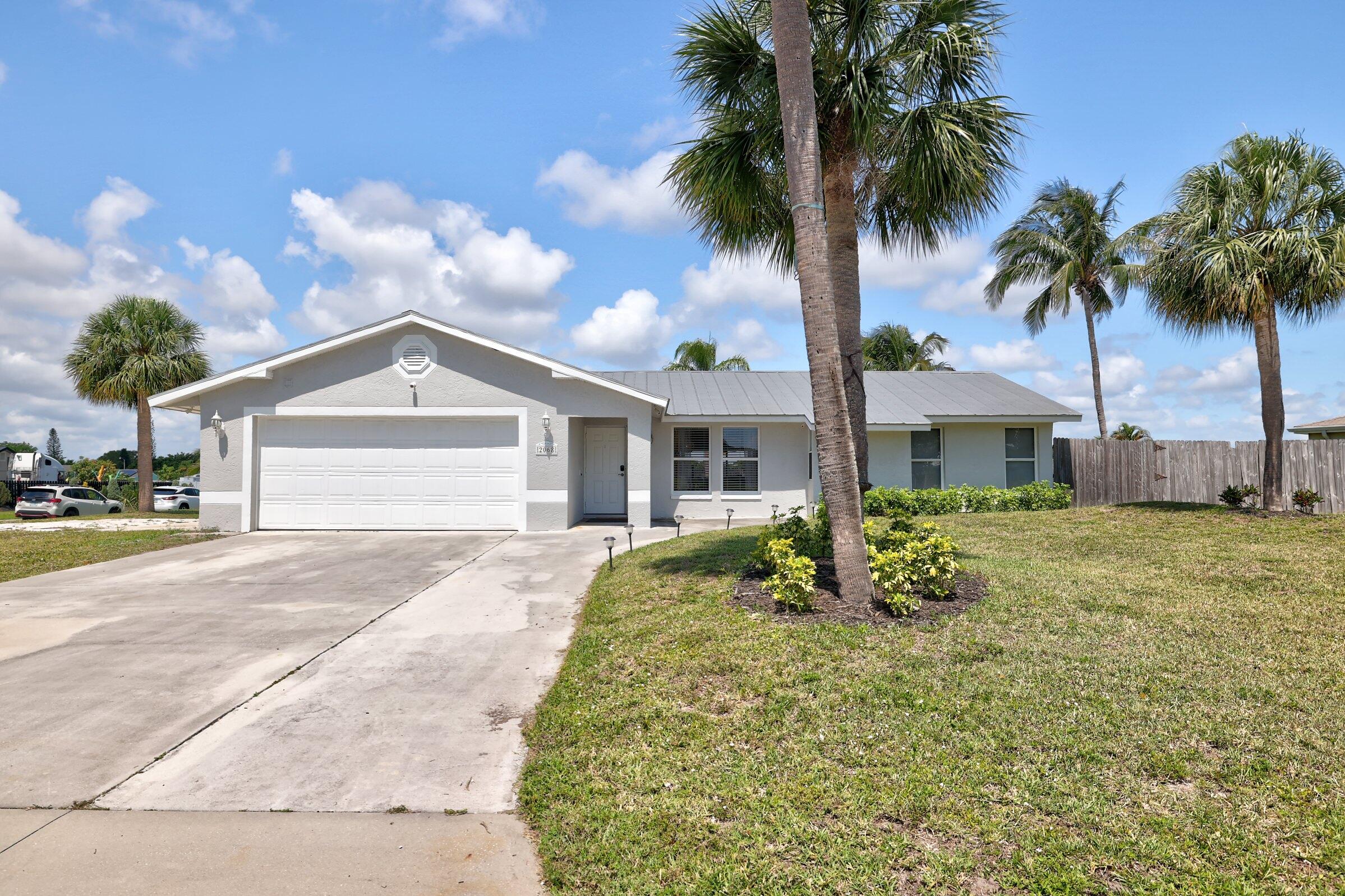 2068 Southeast Triumph Road Port St. Lucie, FL 34952 - Photo 57 of 59 a front view of a house with garden
