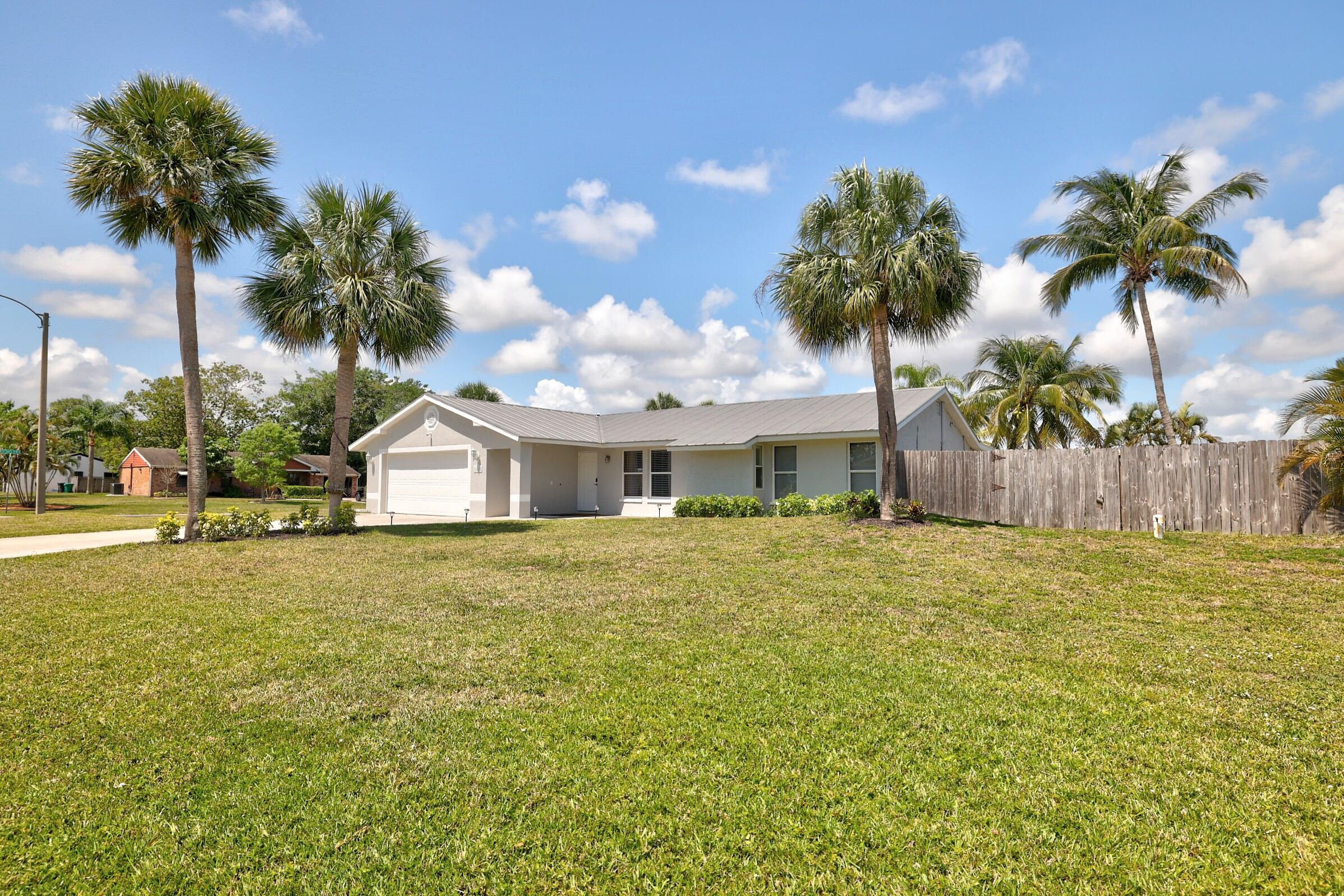 2068 Southeast Triumph Road Port St. Lucie, FL 34952 - Photo 58 of 59 a front view of a house with garden