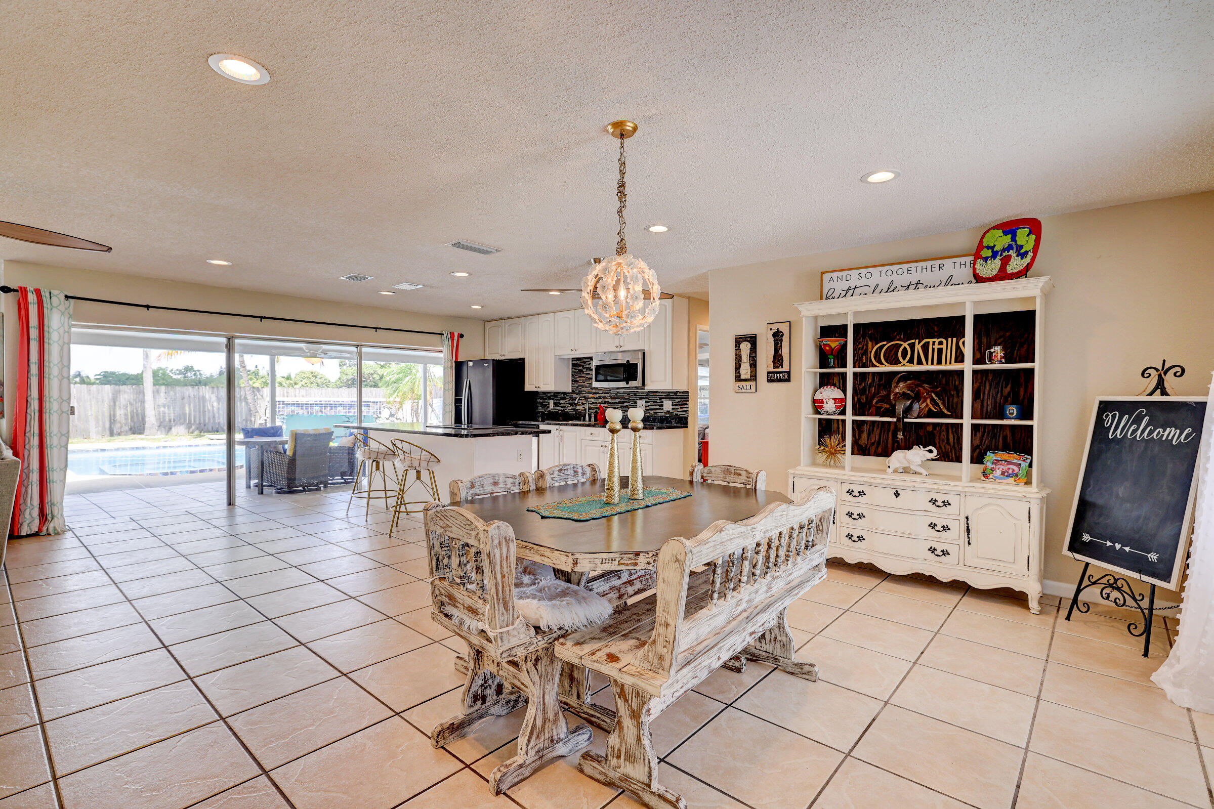 2068 Southeast Triumph Road Port St. Lucie, FL 34952 - Photo 6 of 59 a living room with furniture a dining table and a large window