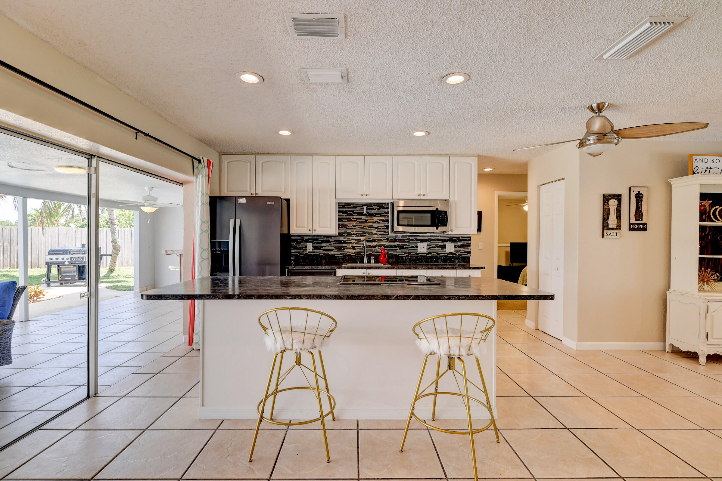 2068 Southeast Triumph Road Port St. Lucie, FL 34952 - Photo 8 of 59 a kitchen with stainless steel appliances granite countertop a refrigerator and a stove top oven