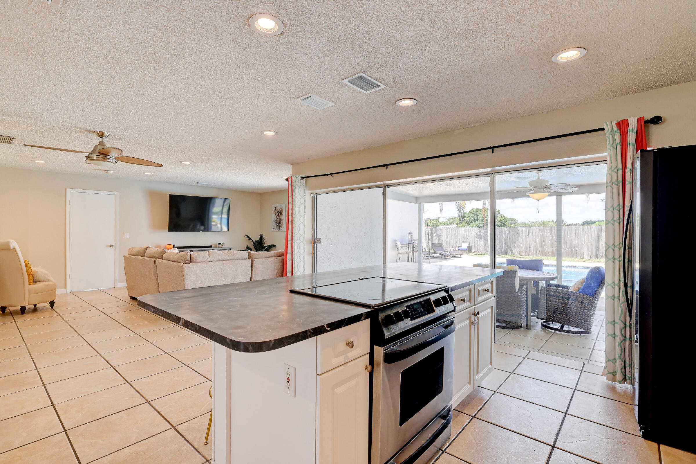 2068 Southeast Triumph Road Port St. Lucie, FL 34952 - Photo 9 of 59 a kitchen that has a sink and a stove in it