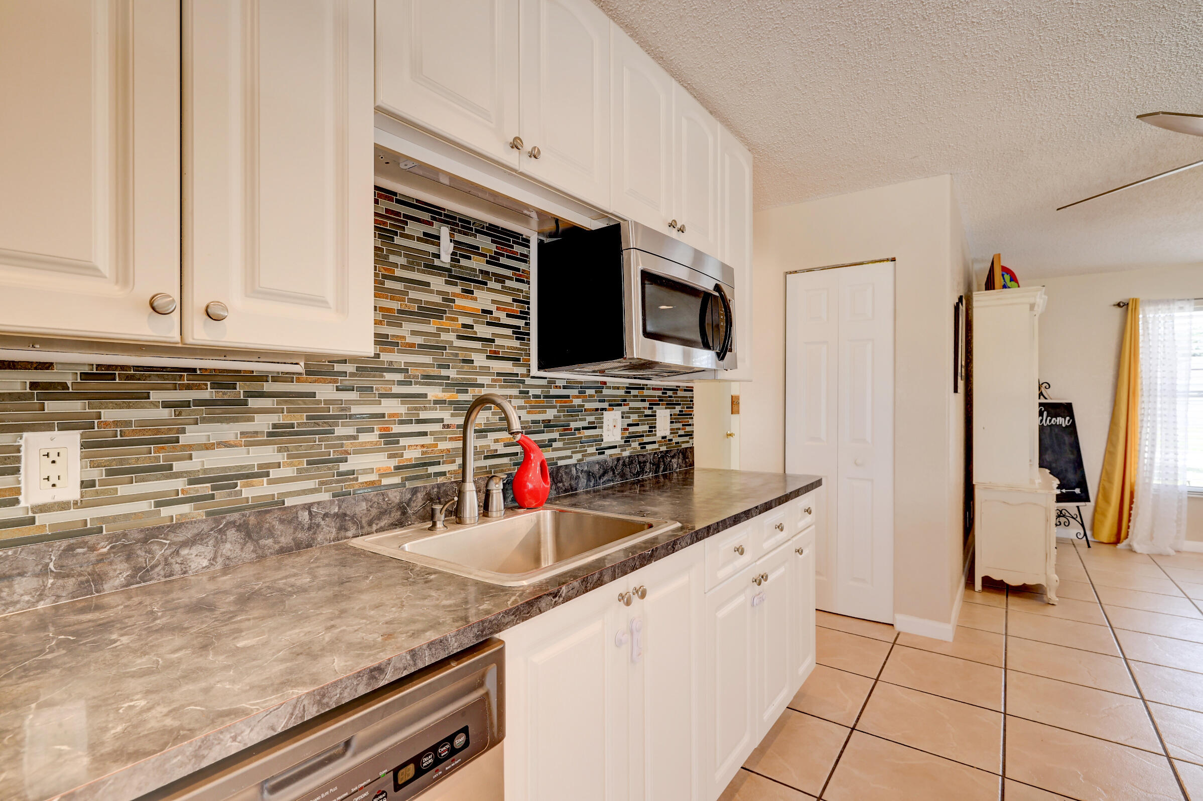 2068 Southeast Triumph Road Port St. Lucie, FL 34952 - Photo 10 of 59 a kitchen with stainless steel appliances a sink dishwasher stove and refrigerator