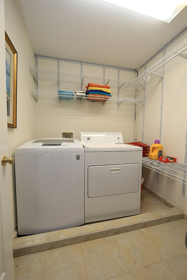 7812 Mayapple Place Raleigh, NC 27613 - Photo 22 of 30 Good storage, shelving in this tile floor laundry room on the second floor. Laundry Room
