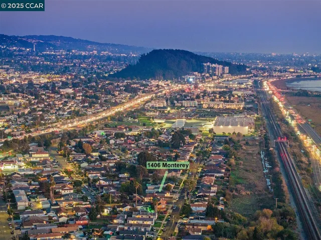 a view of a patio with a table and chairs under an umbrella