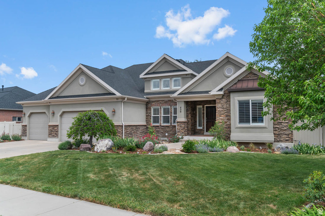 439 East 13540 South Draper, UT 84020 - Photo 45 of 46 Stucco and stone facade with a two-car garage, mature landscaping, and an inviting entryway