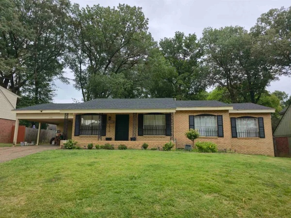 a front view of house with yard and outdoor seating