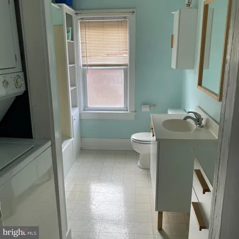 a bathroom with a sink toilet and tub
