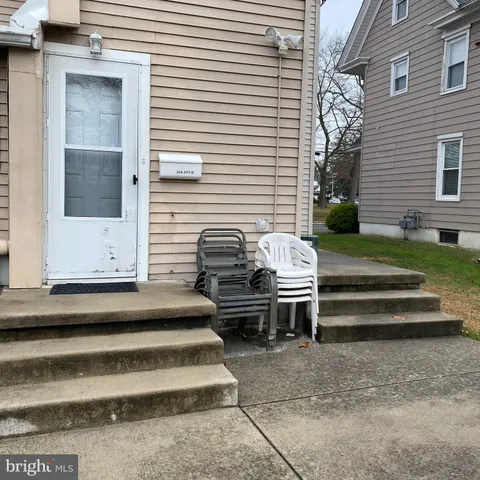 a view of a bench in back side of house