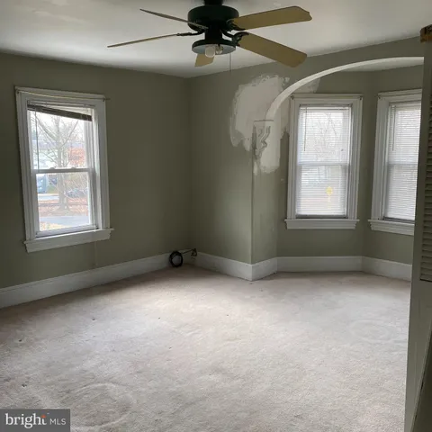 an empty room with a empty space and windows