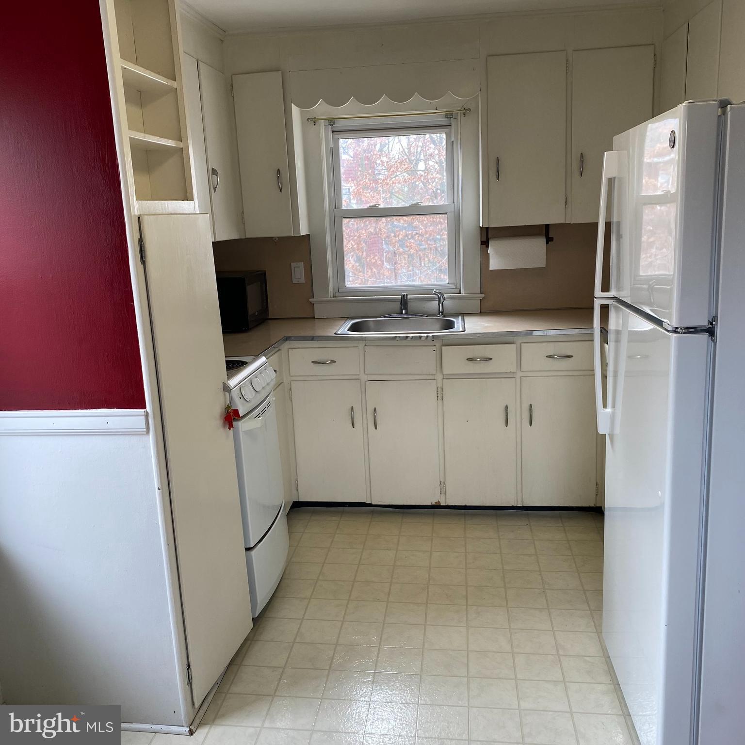 328 328-apt B Broadway Street South, Unit B Pitman, NJ 08071 - Photo 9 of 20 a kitchen with a refrigerator sink and cabinets