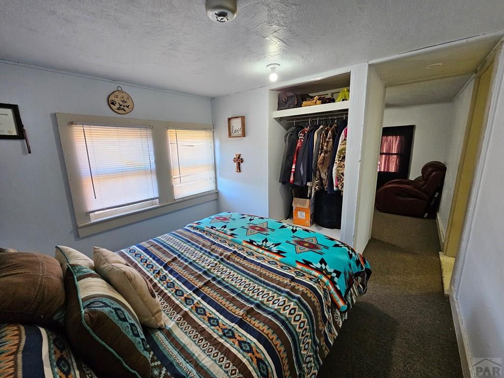 1049 Tipton Street Springfield, CO 81073 - Photo 11 of 20 a bedroom with a bed and a closet