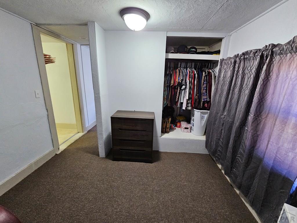 1049 Tipton Street Springfield, CO 81073 - Photo 13 of 20 a view of walk in closet with clothes and shoes