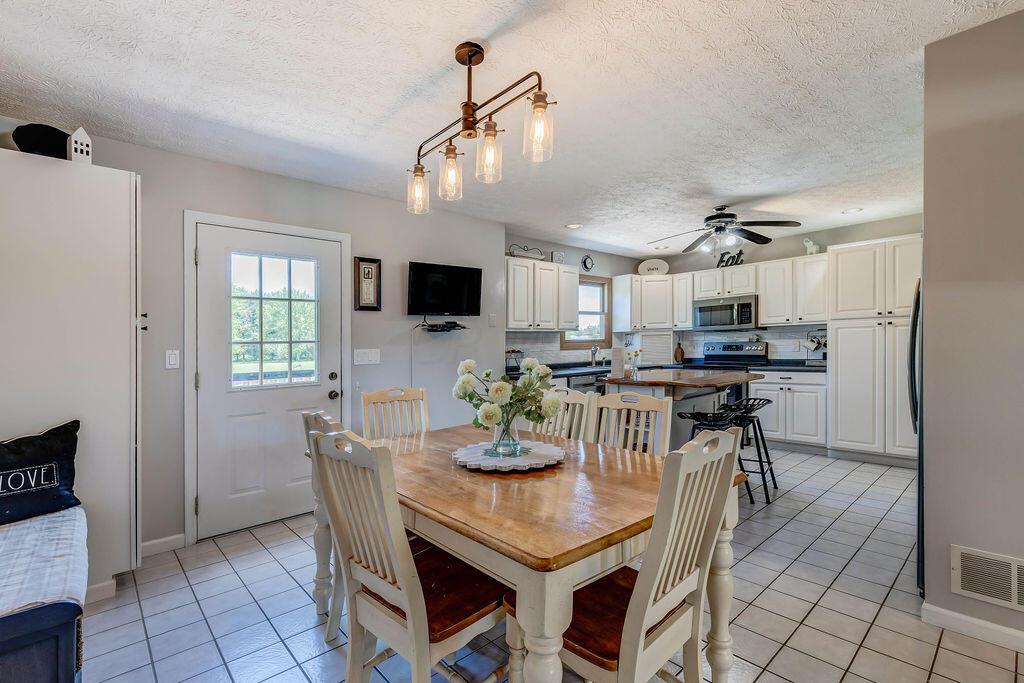 1300 Hubbard Road Galloway, OH 43119 - Photo 21 of 89 • Ceramic tile flooring • Tan painted walls • Ceiling light • Door to rear Deck • Wall pantry • TV is negotiable