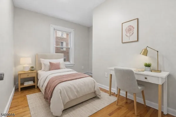 a bedroom with a bed and a desk