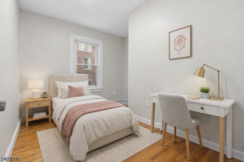 336 Madison Avenue, Unit 2 Newark, NJ 07108 - Photo 9 of 11 a bedroom with a bed and a desk