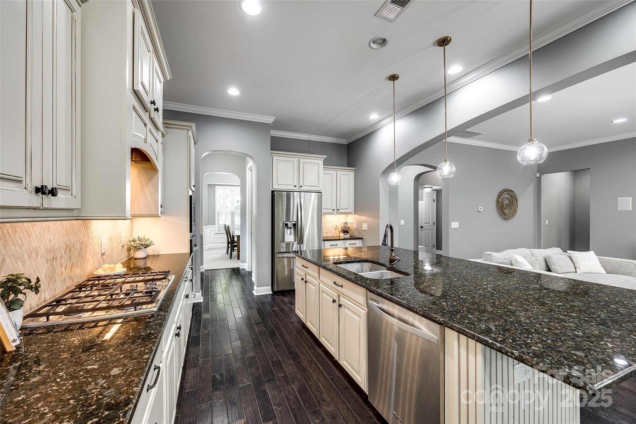 618 Chase Court Fort Mill, SC 29708 - Photo 13 of 48 a large kitchen with stainless steel appliances granite countertop a lot of counter space and wooden floor