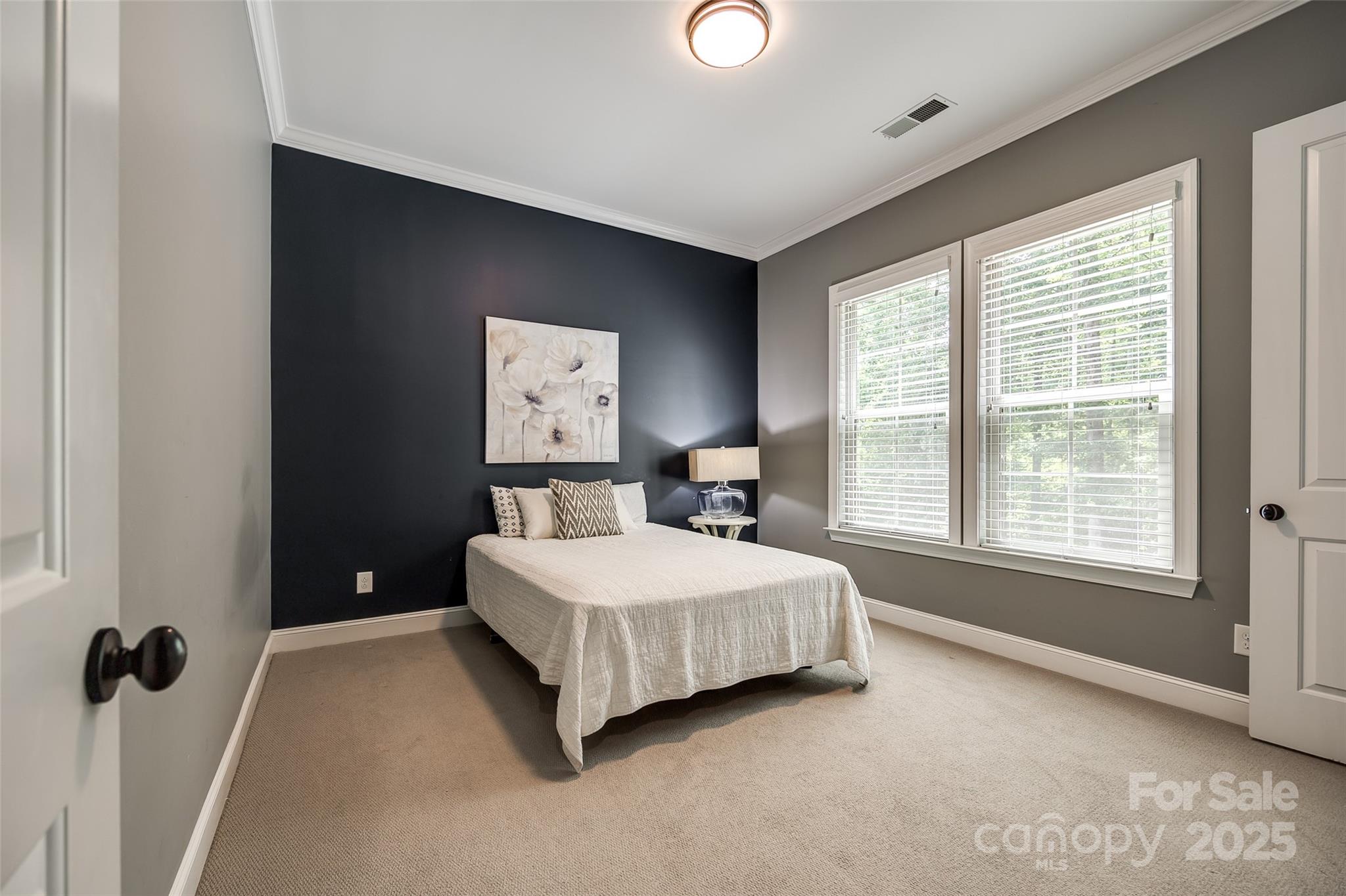 618 Chase Court Fort Mill, SC 29708 - Photo 20 of 48 a spacious bedroom with a bed and a lamp