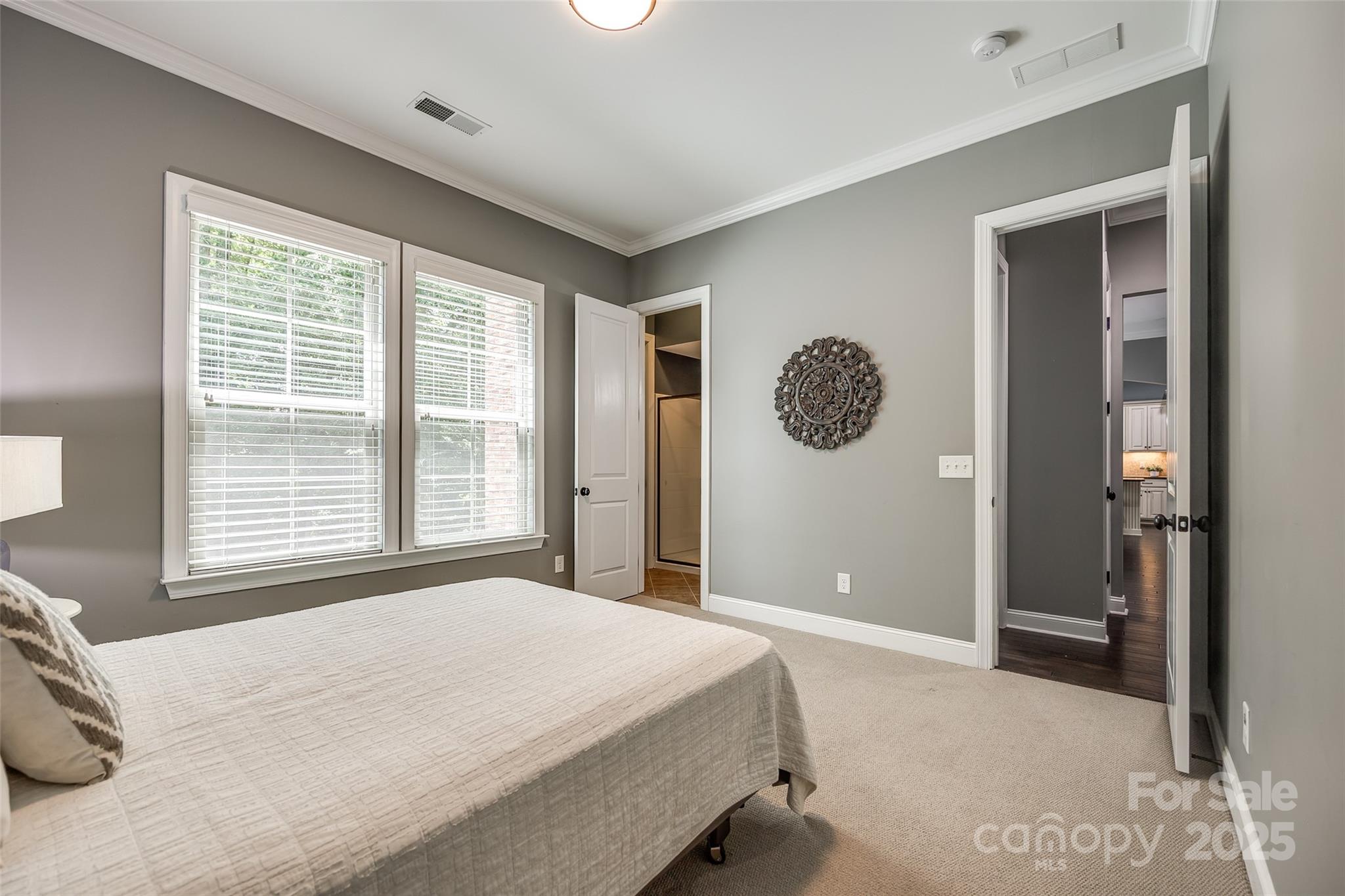 618 Chase Court Fort Mill, SC 29708 - Photo 21 of 48 a bedroom with a large bed and a chandelier