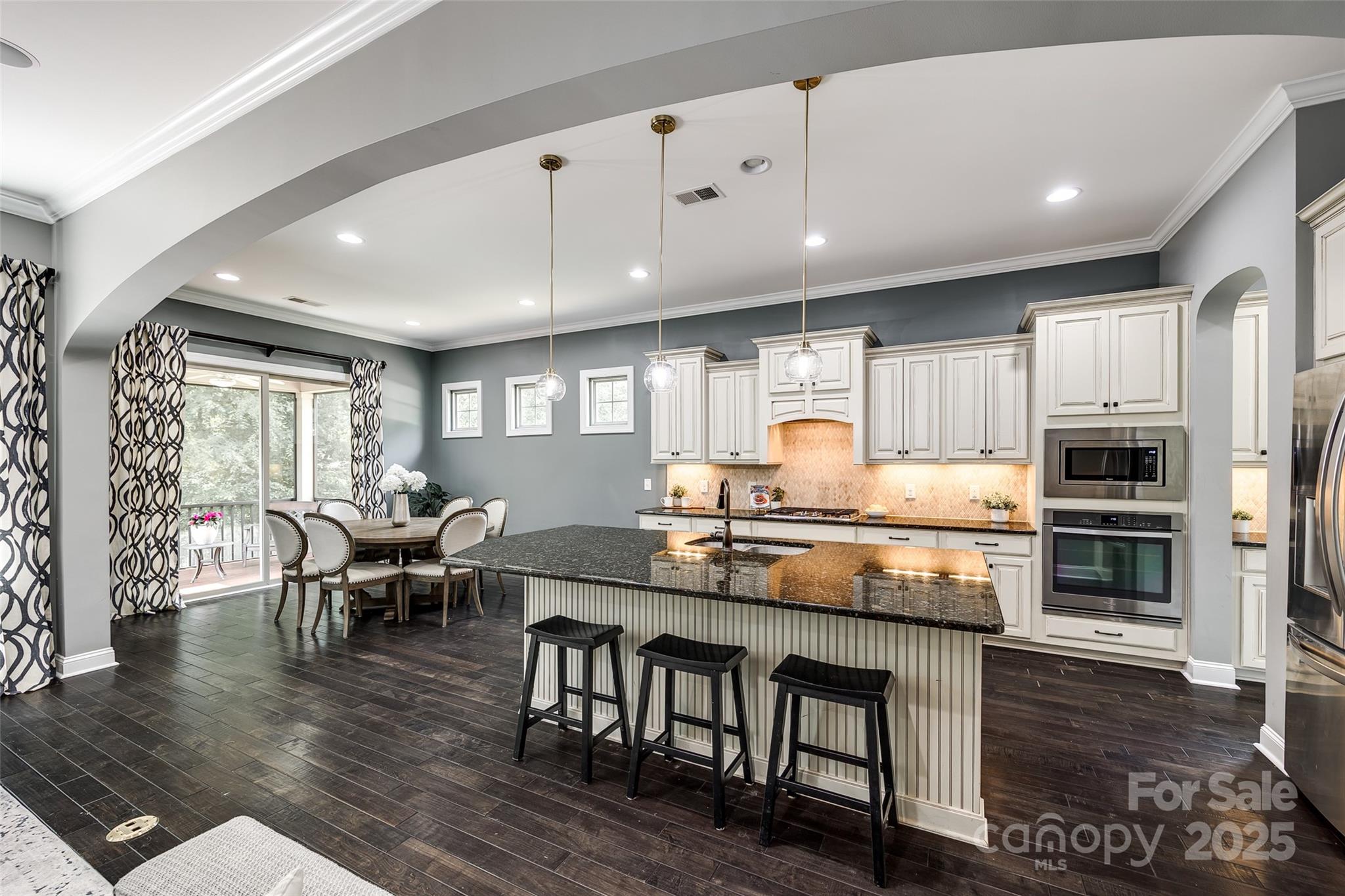 618 Chase Court Fort Mill, SC 29708 - Photo 5 of 48 a kitchen with stainless steel appliances granite countertop a stove top oven a sink dishwasher a dining table and chairs with wooden floor