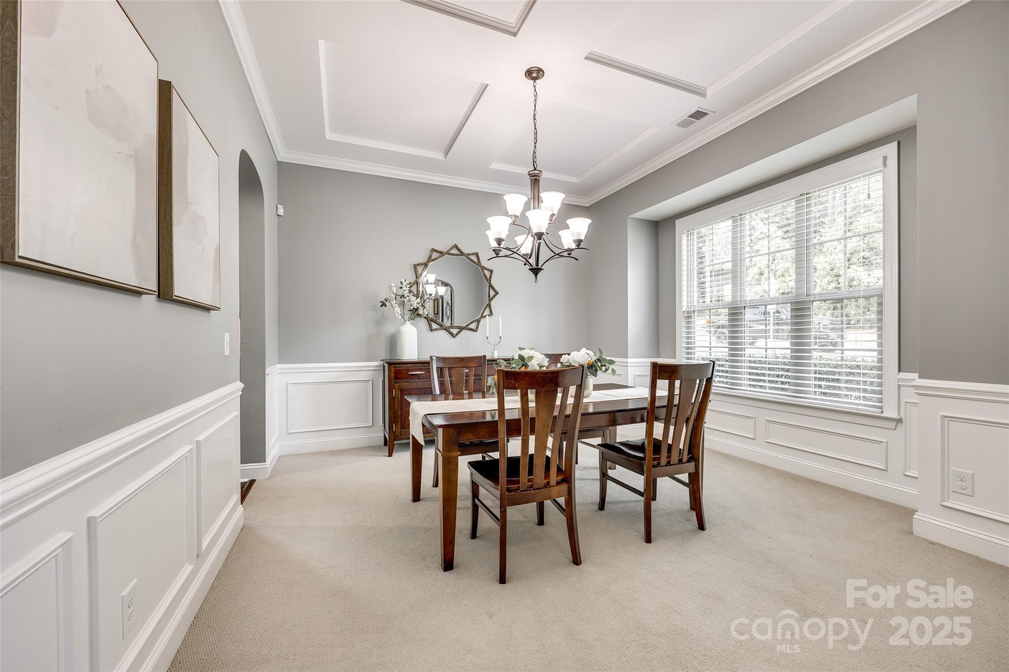 618 Chase Court Fort Mill, SC 29708 - Photo 8 of 48 a view of a dining room with furniture a chandelier and a window