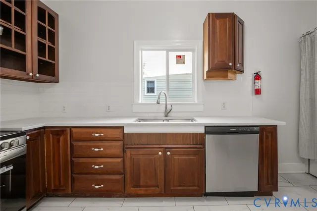 a kitchen with stainless steel appliances granite countertop a sink and a refrigerator