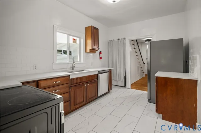 a kitchen with a sink and a refrigerator