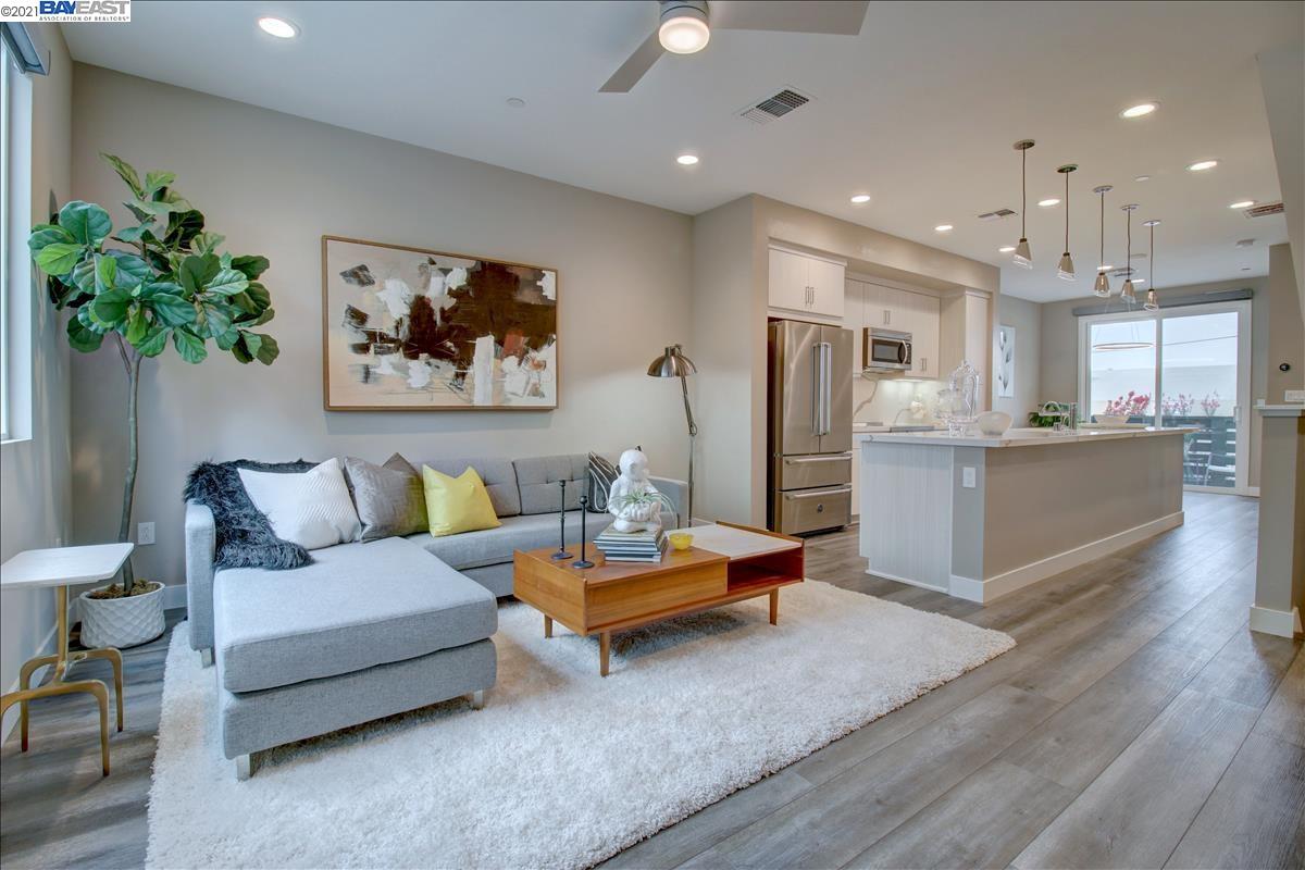 a living room with furniture and kitchen view