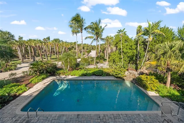a view of a yard with a wooden fence