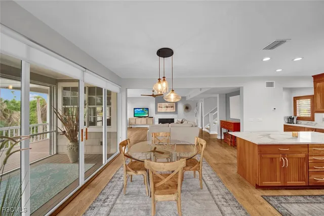 a living room with fireplace furniture and a floor to ceiling window